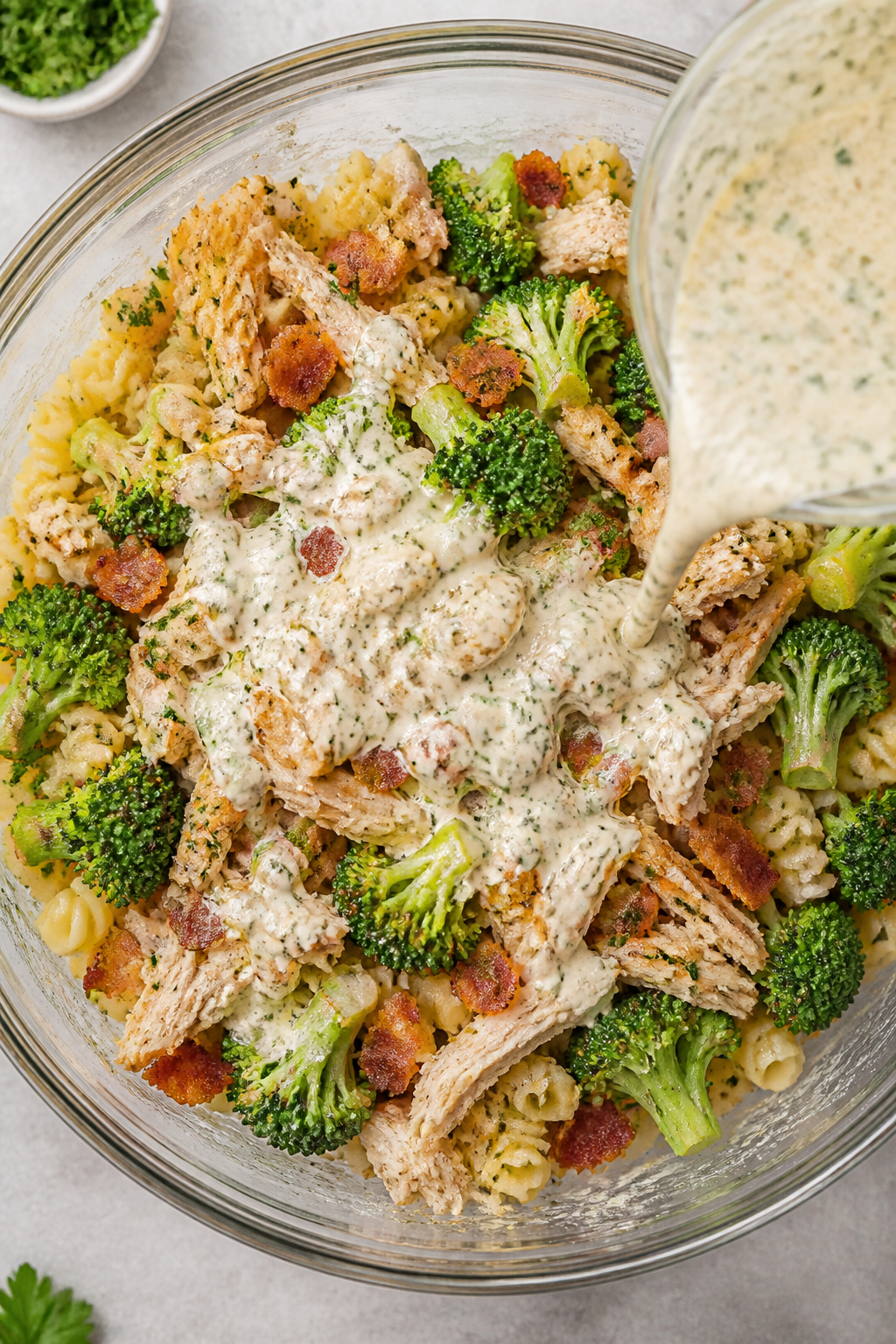 Cooking process: Sautéed broccoli florets, diced yellow onion, and minced garlic being folded toget