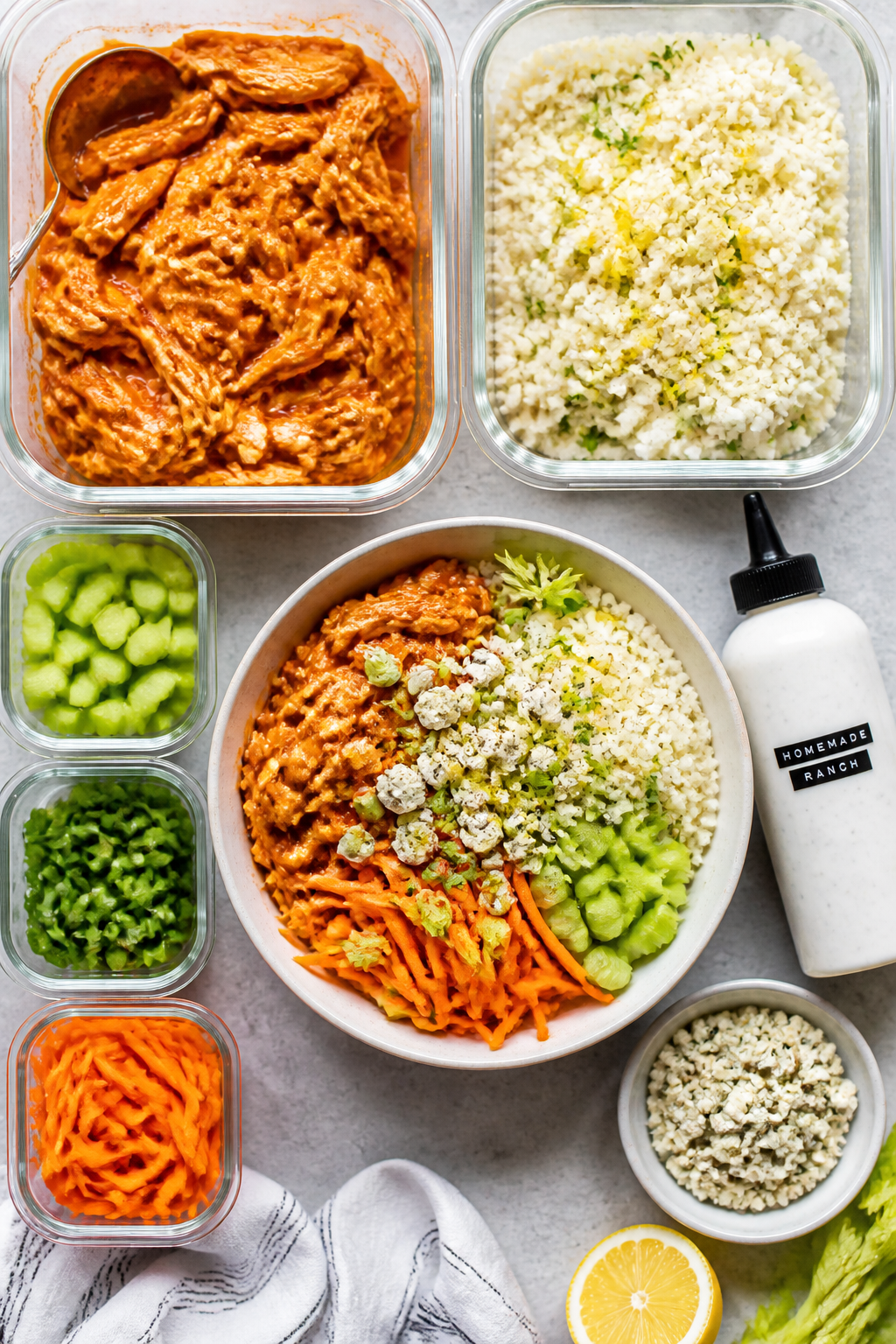 Overhead “tasty top view” meal-prep spread: Multiple open containers arranged neatly—one with 