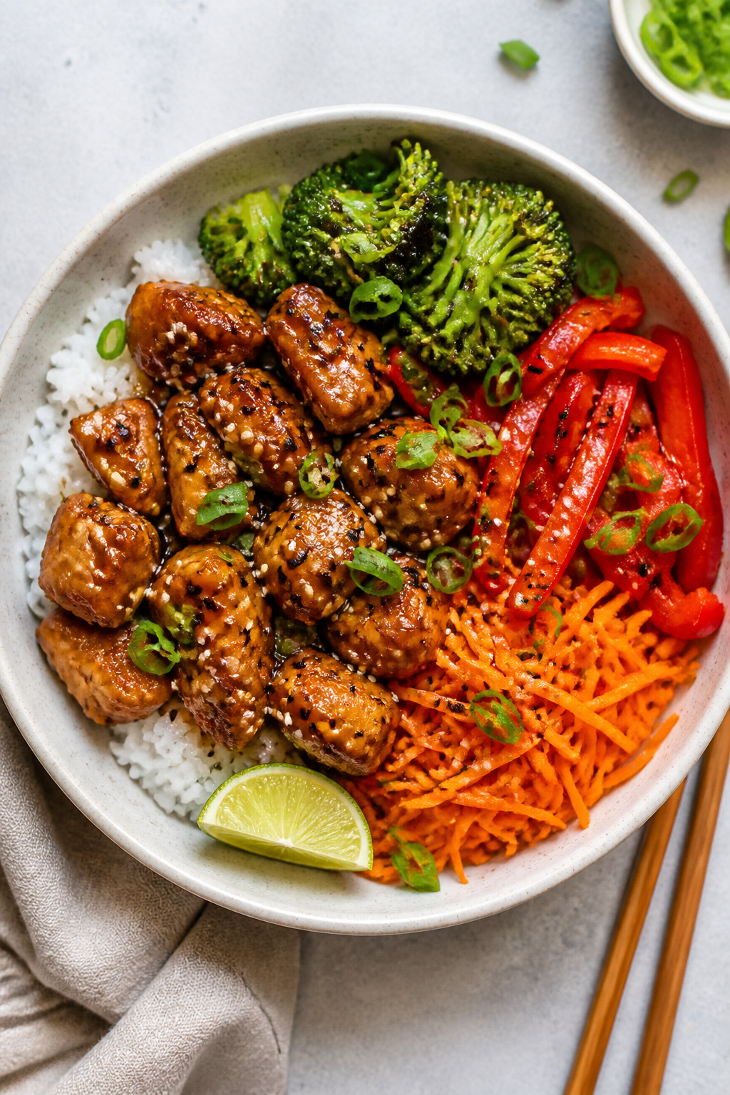 Tasty top view: Overhead shot of assembled Easy Healthy Sesame Chicken Bowl with fluffy jasmine rice