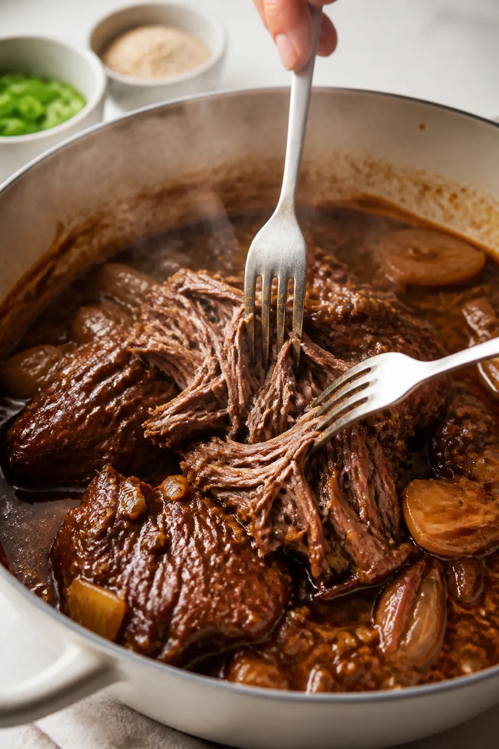 Cooking process close-up: Tender chunks of slow-cooked Korean beef being shredded with two forks in 