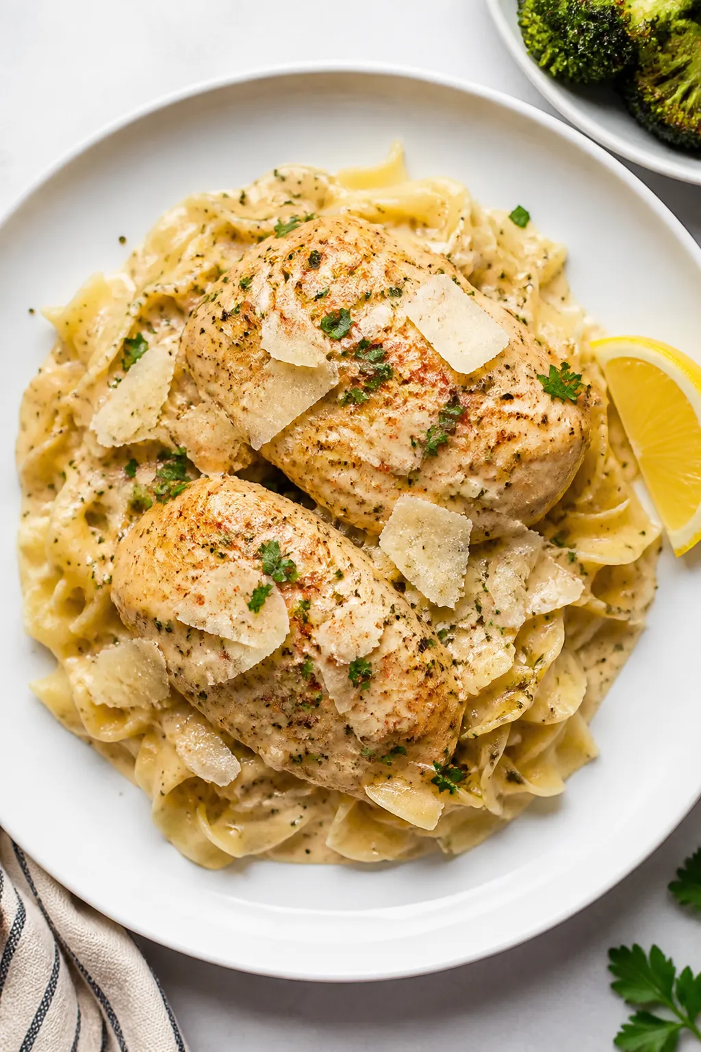Final plated dish: Restaurant-quality presentation of Crockpot Garlic Parmesan Chicken over buttered