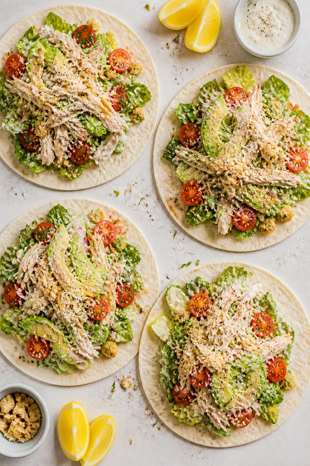 Tasty top view, assembly stage: Overhead shot of four open tortillas on a light stone surface, each 