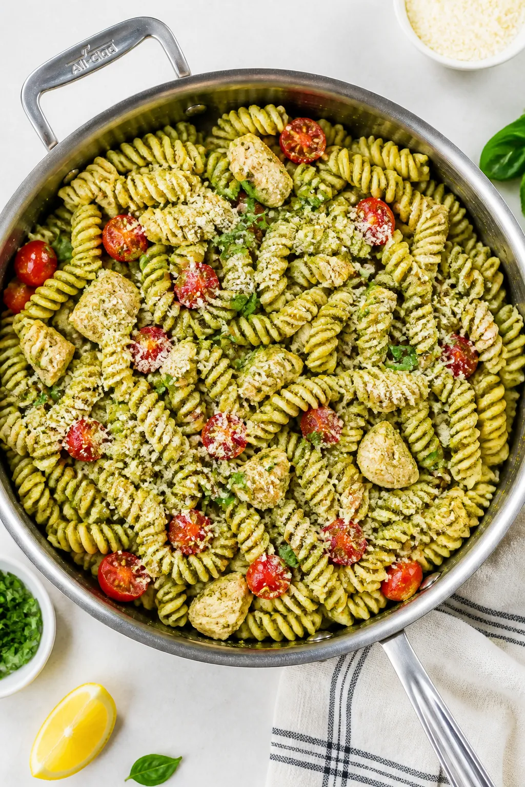 Tasty top view: Overhead shot of high-protein rotini pesto pasta in a wide stainless-steel skillet r